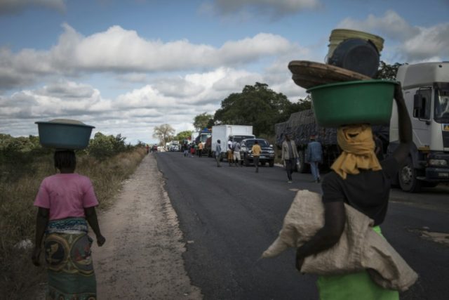 Street vendors sell to drivers along Mozambique's main north-south road as they wait for a
