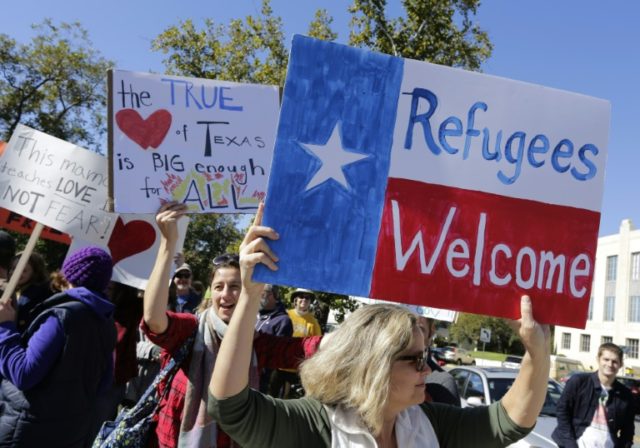 People protest on November 22, 2015 in Austin, Texas in favor of allowing Syrian refugees