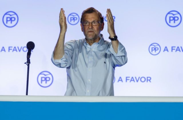 Popular Party (PP) leader Mariano Rajoy greets his supporters during a post-election rally