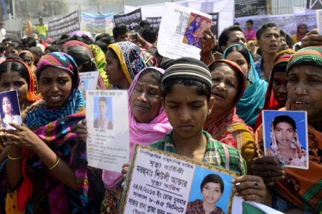 Bangladeshi relatives of missing garment workers take part in a protest marking the first