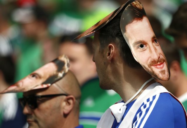 Northern Ireland fans with a mask of forward Will Grigg waiting for the start of their Eur