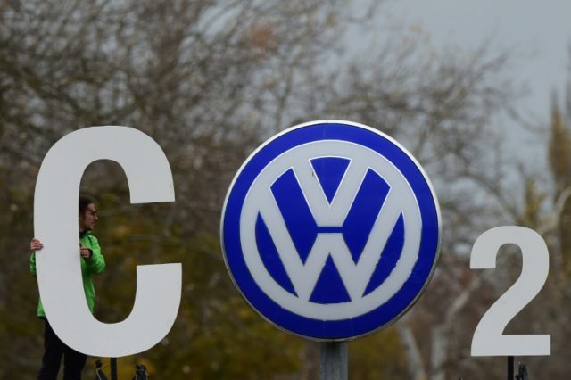 A Greenpeace activist makes a CO2 sign at Volkswagen's headquarters in Wolfsburg, on Novem