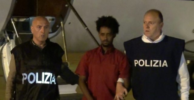 Italian police escort Medhanie Yehdego Mered, afte the alleged people smuggler was extradi