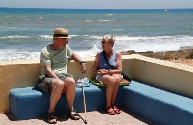 Michael (left) and Rosalind Smith sit next to a beach in Orihuela