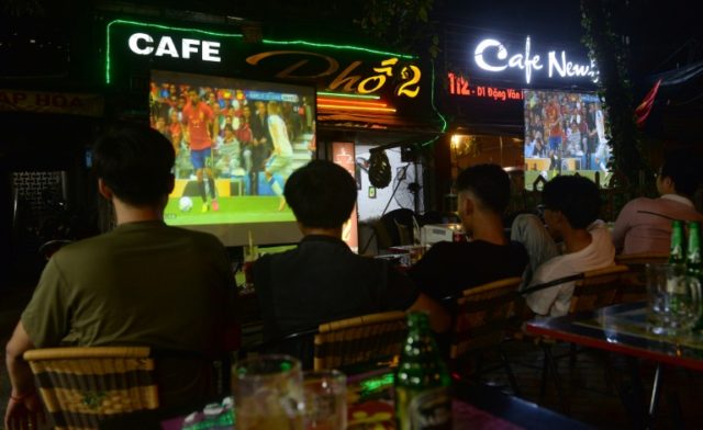 Men watch a live broadcast of Euro2016 in downtown Hanoi