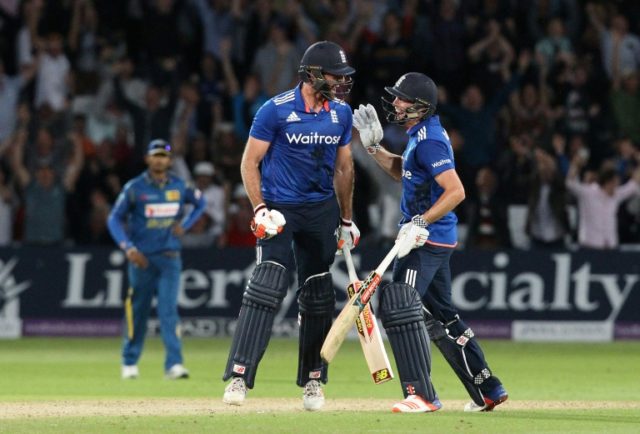 England's Liam Plunkett (L) celebrates with Chris Woakes after Plunkett hit a six off the