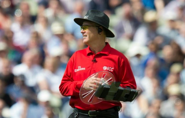 Umpire Bruce Oxenford wears a protective shield on his left arm during play in the second