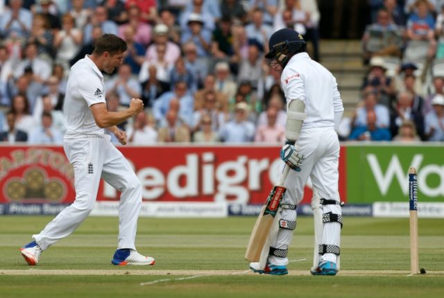 England's Chris Woakes (left) celebrates taking the wicket of Sri Lanka's Kusal Mendis on