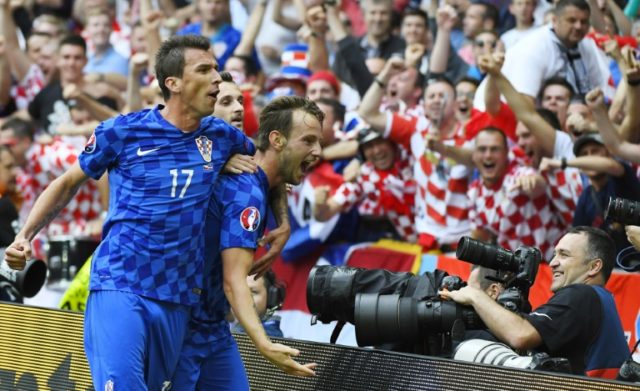 Croatia's midfielder Ivan Rakitic (R) celebrates a goal with Mario Mandzukic (L) during th