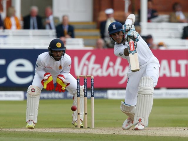 England's Alex Hales (R) plays a shot watched by Sri Lanka's wicketkeeper Dinesh Chandimal