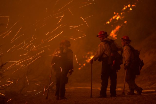 Embers blow around firefighters, June 17, 2016 at the Sherpa Fire near Santa Barbara, Cali