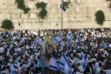 Israelis gather at the Western Wall in Jerusalem's old city on June 5, 2016 with their national flags as they celebrate the Jerusalem day which marks Israel's 1967 seizure of the Palestinian-dominated eastern half of Jerusalem