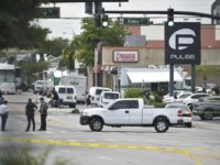 Police stand near the area of the mass shooting at the Pulse nightclub in Orlando, Florida on June 12, 2016 Police stand near the area of the mass shooting at the Pulse nightclub in Orlando, Florida on June 12, 2016