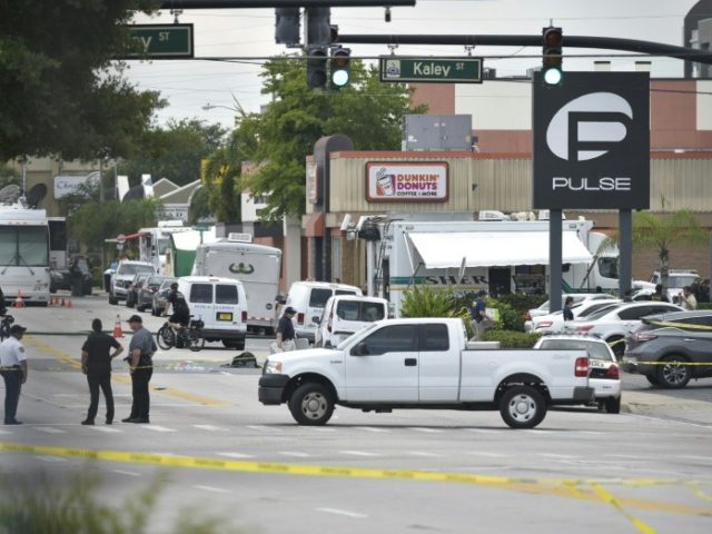 Police stand near the area of the mass shooting at the Pulse nightclub in Orlando, Florida