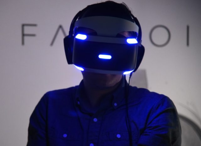 A man tries the new Sony VR headset at the E3 video game gathering in Los Angeles, Califor