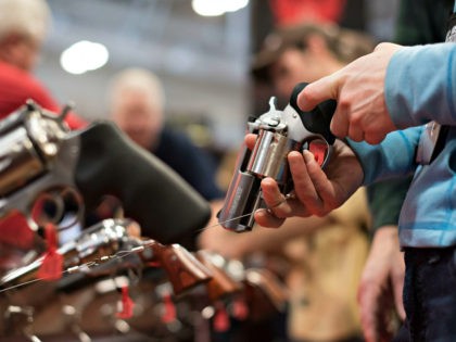 An attendee handles a revolver in the Sturm, Ruger & Co., Inc. booth on the exhibition floor of the 144th National Rifle Association (NRA) Annual Meetings and Exhibits at the Music City Center in Nashville, Tennessee, U.S., on Saturday, April 11, 2015. Top Republican contenders for their party's 2016 presidential …