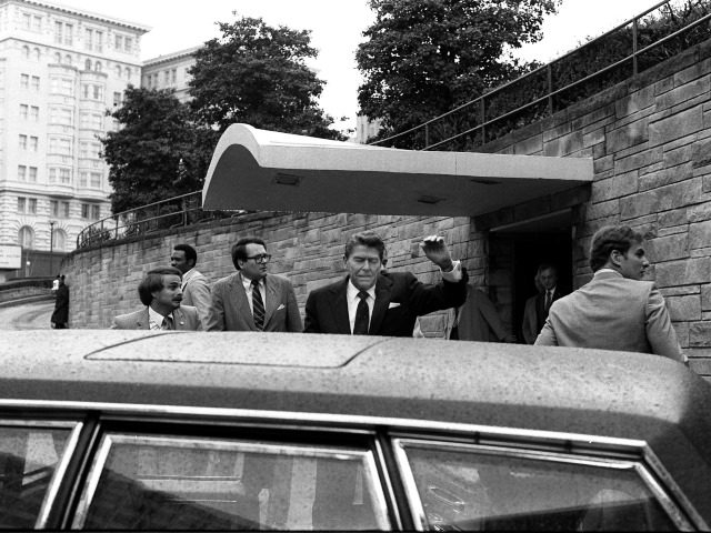 U.S. President Ronald Reagan being shoved into the President's limousine by secret service agents after being shot outside a Washington hotel Monday, March 30, 1981. (AP Photo/Ron Edmonds)