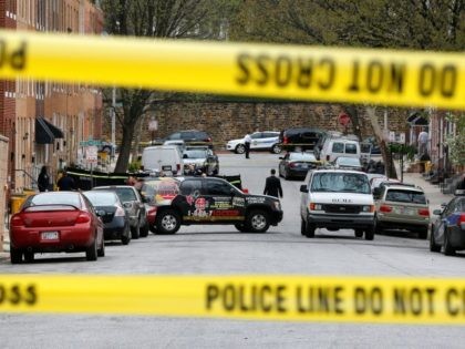 Officials investigate the scene of a police-involved shooting in Baltimore, Thursday, Marc