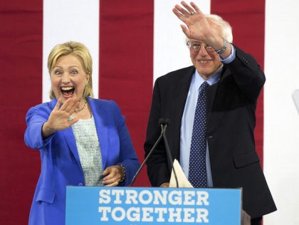 Democratic presidential candidate Hillary Clinton waves with her Democratic rival Sen. Be