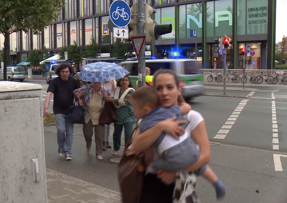 Members of the public run away from the Olympia Einkaufszentrum mall, after a shooting, in Munich, Germany, Friday, July 22, 2016. A manhunt was underway Friday for a shooter or shooters who opened fire at a shopping mall in Munich, killing and wounding several people, a Munich police spokeswoman said. The city transit system shut down and police asked people to avoid public places. (AP)