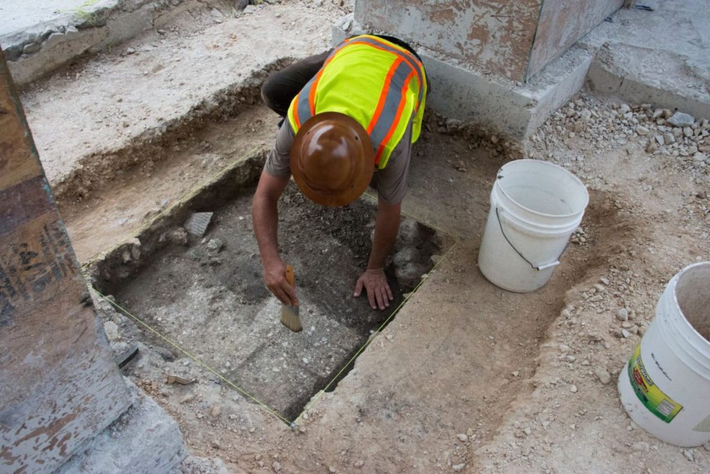 Workman uncovers brick from Alamo wall during archeological dig. (Photo: Texas General Land Office)