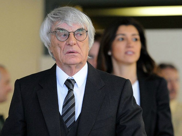 Formula One boss Bernie Ecclestone and his wife Fabiana Flosi leaves the court room of the district court in Munich, Germany, 13 May 2014. Ecclestone stands accused of paying former member of the board of BayernLB 44 million euros in bribes and taking a huge part of that sum back …