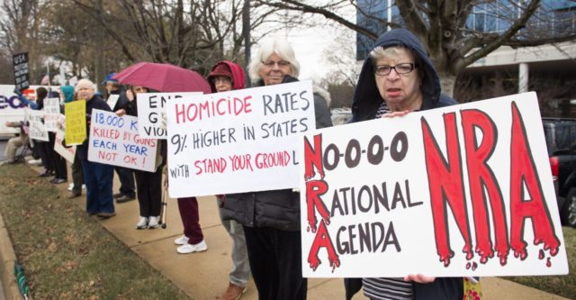 Members of the Reston-Herndon Alliance To End Gun Violence hold a vigil with the goal that the National Rifle Association (NRA) " stop standing in the way of sensible gun legislation reforms aimed at preventing criminals and adjudicated mentally unstable individuals from purchasing guns" as they march on the sidwalk …