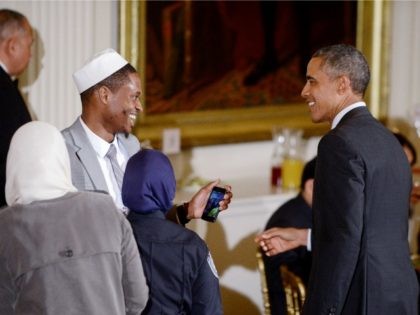 US President Barack Obama greets guests during an Iftar dinner celebrating Ramadan in the East Room of the White House in Washington, DC, July 22, 2015.Photo by