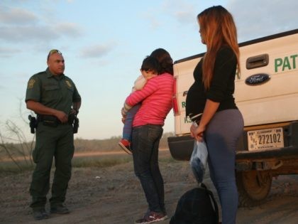 An immigrant from El Salvador, seven months pregnant, she said, stands next to a U.S. Border Patrol truck after she and others turned themselves in to border agents on December 7, 2015 near Rio Grande City, Texas. Many pregnant women, according to Border Patrol agents, cross illegally into the U.S. …