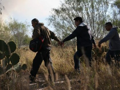 Immigrants walk handcuffed after illegally crossing the U.S.-Mexico border and being caught by the U.S. Border Patrol on December 7, 2015 near Rio Grande City, Texas. Border Patrol agents continue to capture hundreds of thousands of undocumented immigrants, even as the total numbers of those crossing has gone down. (Photo …