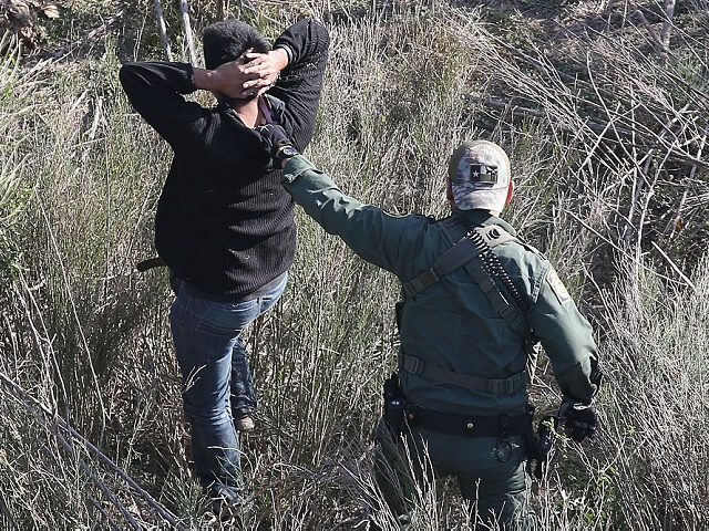 LA GRULLA, TX - DECEMBER 09: A U.S. Customs and Border Protection agent detains undocumented immigrants near the U.S.-Mexico border on December 10, 2015 at La Grulla, Texas. Border security remains a key issue in the U.S. Presidential campaign. (Photo by John Moore/Getty Images)