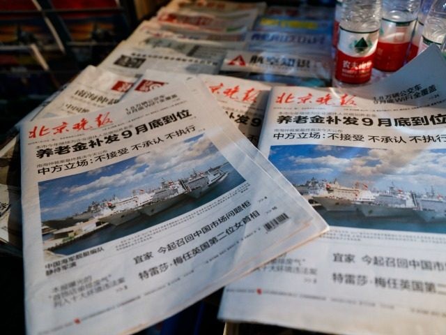 In this photo illustration, Beijing Evening newspaper headlines of the Chinese naval fleet