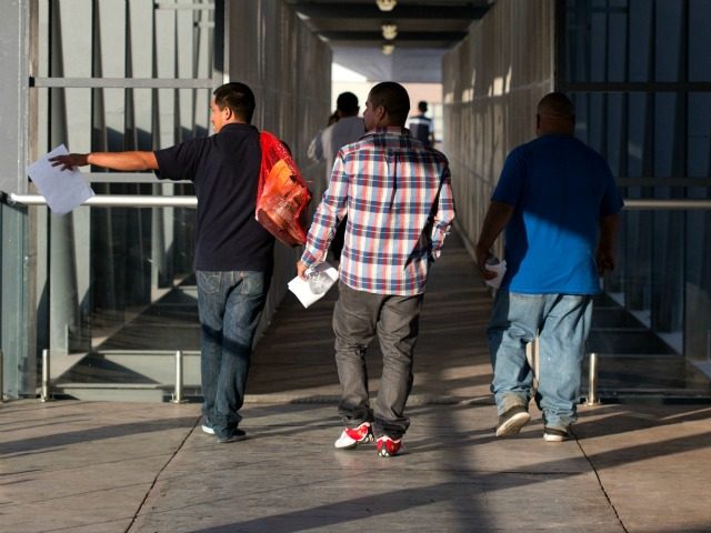 Mexicans deported from the US walk at El Chaparral repatriation center in Tijuana, northwestern Mexico, in the border with the US on June 30, 2016. Some 30,000 Mexicans, of a total of 207,398 deported from the US, were expelled through Tijuana in 2015, according to Mexican official figures. / AFP …