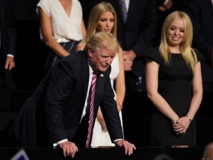 Republican presidential candidate Donald Trump (L) speaks to delegates as Ivanka Trump (C)