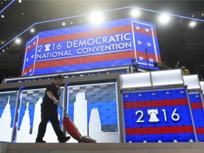 A worker vacuums the stage prior to the start of Day 1 of the Democratic National Convention at the Wells Fargo Center in Philadelphia, Pennsylvania, July 25, 2016. / AFP / SAUL LOEB (Photo credit should read