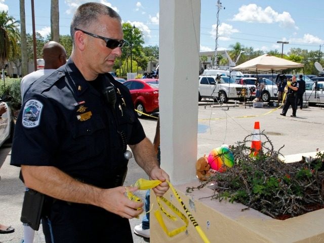 FORT MYERS, FL - JULY 25: Police remove the crime scene tape after finishing their investi