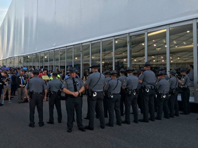 Secret service agents and rangers contain a protest area occupied by Bernie Sanders suppor