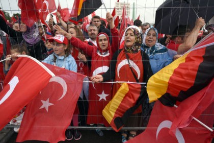 Supporters of Turkish President Recep Tayyip Erdogan attend a rally with German and Turkish flags on July 31, 2016 in Cologne, as tensions over Turkey's failed coup put authorities on edge. Police said some 20,000 people had joined in the demonstration staged by groups including the pro-Erdogan Union of European-Turkish …