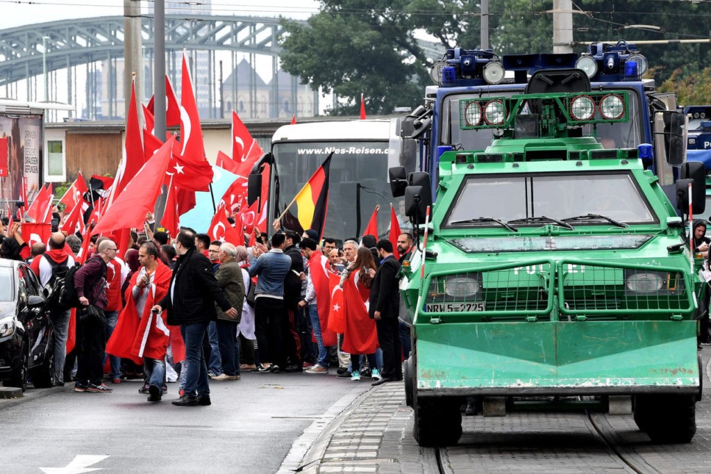 COLOGNE, GERMANY - JULY 31: Supporters of Turkish President Recep Tayyip Erdogan rally at a gathering on July 31, 2016 in Cologne, Germany. Cologne and surrounding cities are home to tens of thousands of people of Turkish descent. Erdogan has pursued strong-handed measures following the recent coup attempt by elements of the Turkish armed forces that include the shuttering of media outlets and the arrest of journalists as well as suspensions of ten of thousands of university professors, public servants and police members. (Photo by Sascha Steinbach/Getty Images)