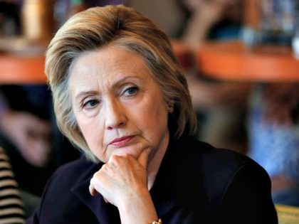 Hillary looks over APPaul Sancya