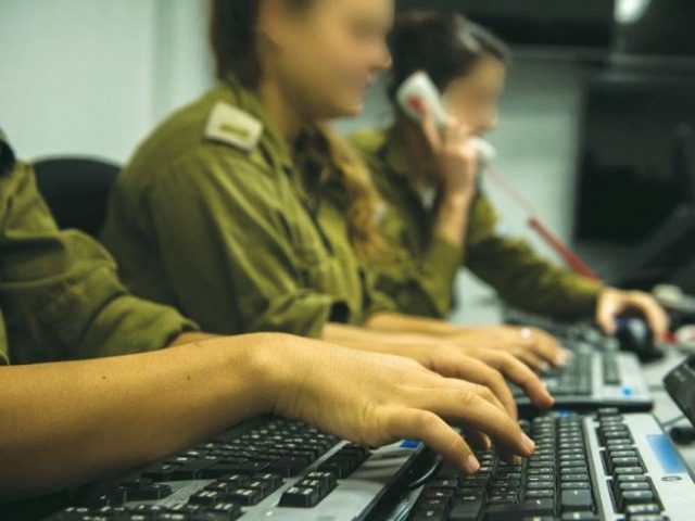 Israeli SOLDIERS AT the military’s Fire Control Center monitor enemy activity in the Gaz