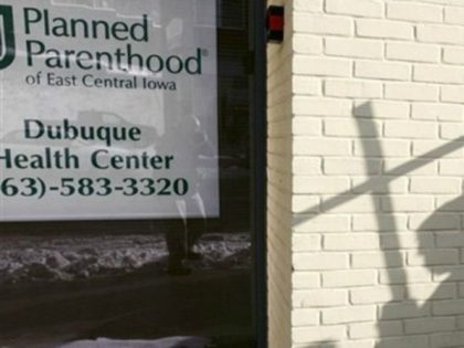 In this Jan. 22, 2009, file photo, the shadow of an anti-abortion activist holding a cross can be seen near a Planned Parenthood in Dubuque, Iowa.