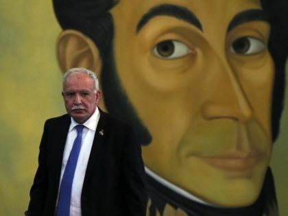 Palestinian Foreign Minister Riyad al-Maliki is seen in front of a portrait of Venezuelan