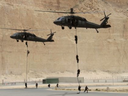 Jordanian and US special forces conduct fast-roping from a Black Hawk helicopter at the King Abdullah Special Operations Training Centre in Amman on May 27, 2012 during their 'Eager Lion' military exercise which is described as the largest exercise in the Middle East in 10 years. The exercise conducted by …