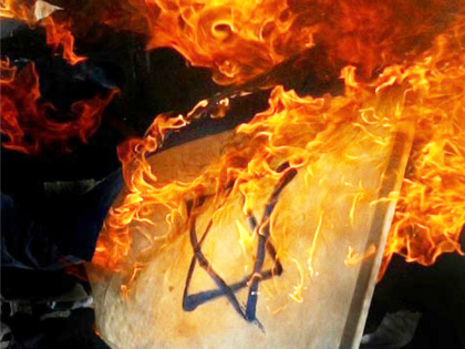 GAZA CITY, GAZA STRIP - APRIL 17: The Israeli flag is burned by Palestinian militants during an anti-Israel rally on April 17, 2004, in Gaza, Gaza Strip. Thousands of palestinians attended demonstrations, to support prisoners who are held in israeli jails in towns and refugee camps along the Gaza Strip, …