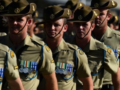 Australian soldiers from the Royal Australian Regiment march onto the parade ground at Lav