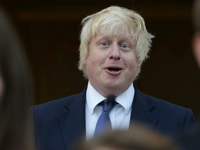 British Foreign Secretary Boris Johnson (C) reacts as he sings the French national Anthem