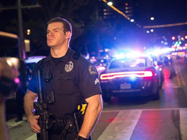 A Police officer stands guard at a baracade following the sniper shooting in Dallas on July 7, 2016. A fourth police officer was killed and two suspected snipers were in custody after a protest late Thursday against police brutality in Dallas, authorities said. One suspect had turned himself in and …