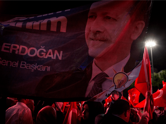 People wave Turkish flags during a march around Kizilay Square in reaction to the attempte