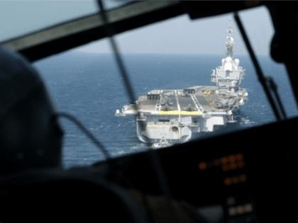 A French navy Dolphin helicopter approaches the aircraft carrier Charles de Gaulle operating in the Gulf on February 26, 2015. French warplanes carried out their first strikes on February 25, 2015 since the warship joined the fight against jihadists in Iraq. AFP PHOTO / PATRICK BAZ (Photo credit should read …